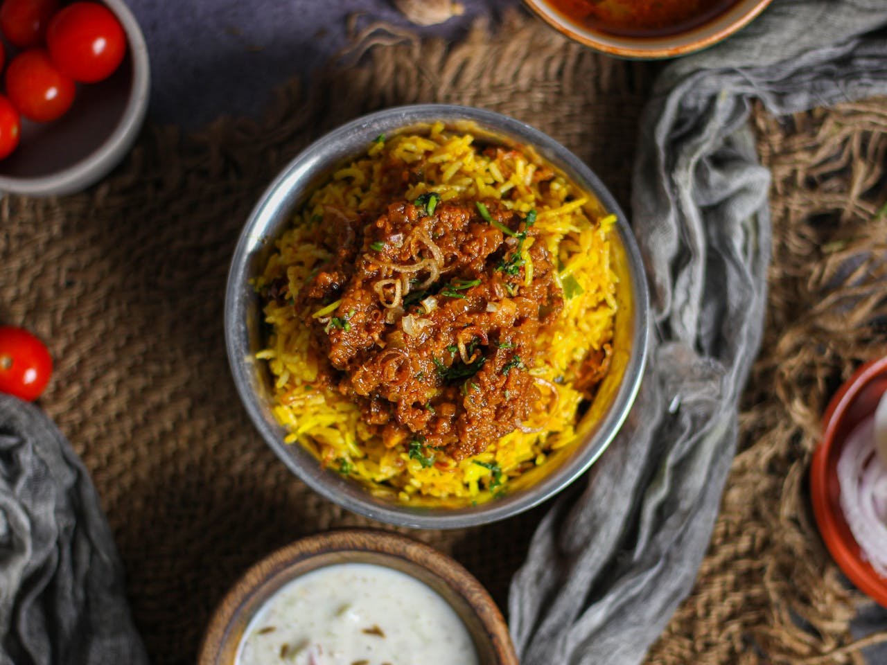 Top view of spicy Indian biryani served with raita, a perfect blend of flavors.