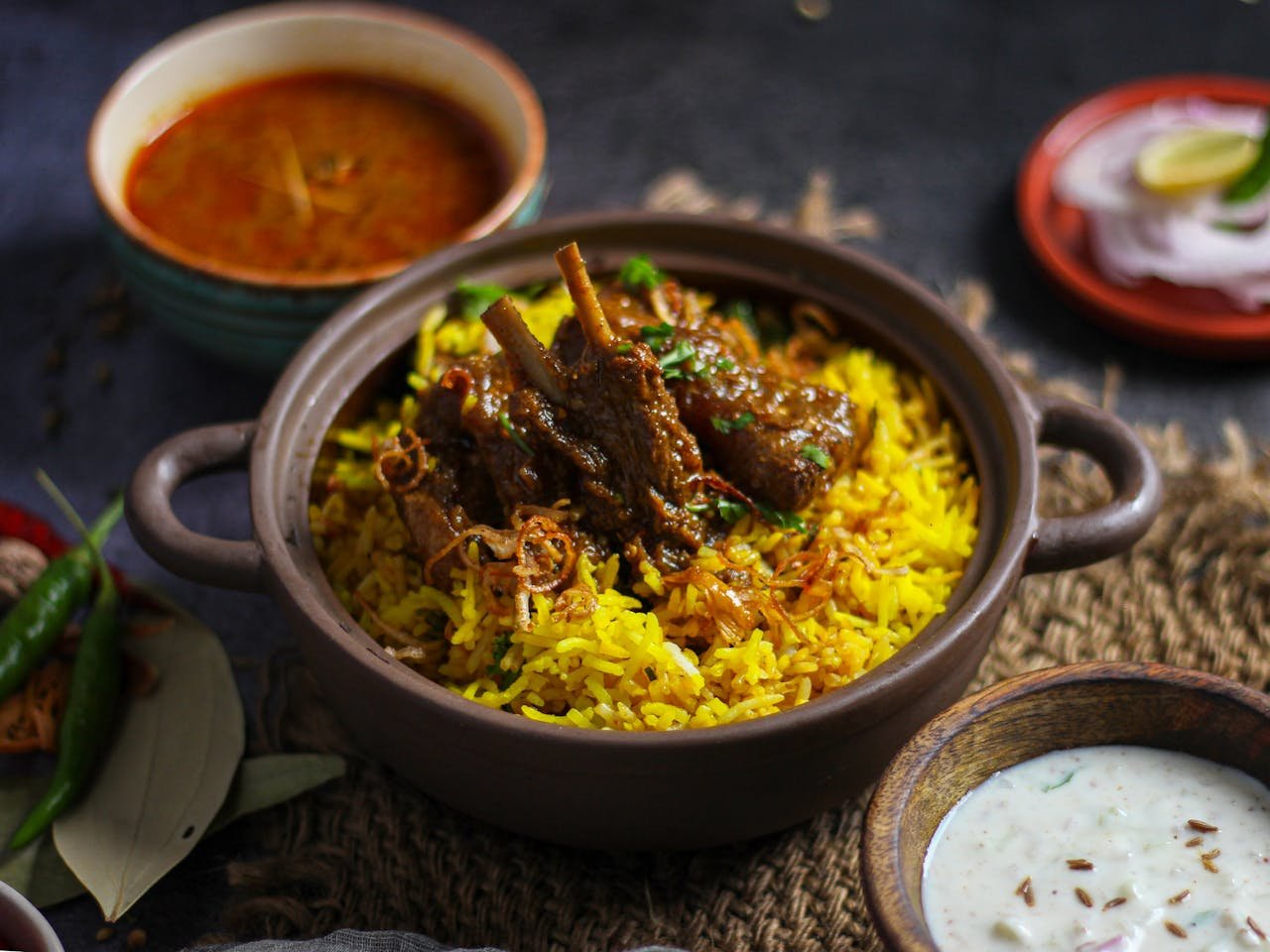Savor the rich flavors of lamb biryani, perfectly spiced and served with traditional sides.