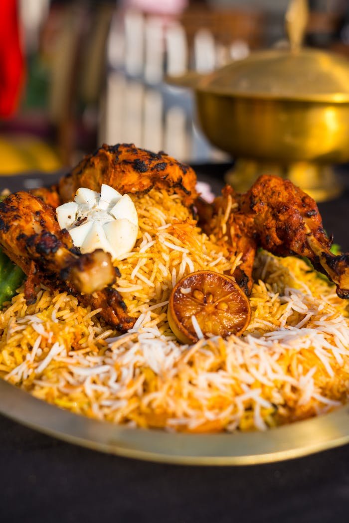 Savor the flavors of traditional Indian biryani with tender grilled chicken in this mouthwatering food photography shot.